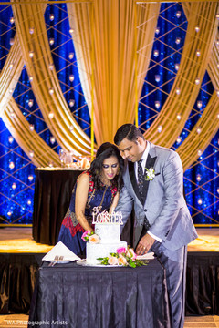 Indian newlyweds getting ready to cut their cake Indian newlyweds getting ready to cut their cake