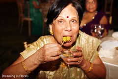 Indian wedding guest enjoying a drink Indian wedding guest enjoying a drink