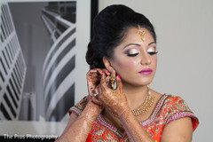 Indian bride getting the final jewelry on. Indian bride getting the final jewelry on.