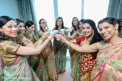 Cute indian bride with bridesmaids making a toast Cute indian bride with bridesmaids making a toast