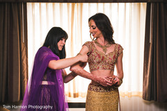 Indian bridesmaid helping maharani Indian bridesmaid helping maharani