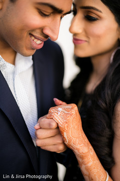 Indian groom admiring bride's engagement ring Indian groom admiring bride's engagement ring