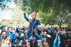 Indian groom being lifted up during baraat Indian groom being lifted up during baraat