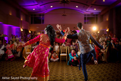 Indian bride and groom dancing during sangeet Indian bride and groom dancing during sangeet