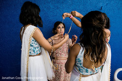 Indian bride being helped to get ready Indian bride being helped to get ready