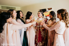 Indian bride and bridesmaids joyfully toasting Indian bride and bridesmaids joyfully toasting