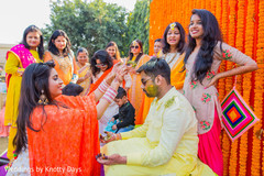 Indian groom is smeared in yellow turmeric paste at his first wedding ceremony ritual Indian groom is smeared in yellow turmeric paste at his first wedding ceremony ritual