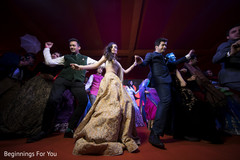 Indian bride and groom dancing with guests Indian bride and groom dancing with guests
