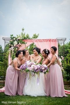 Glamorous indian bride posing with bridesmaids Glamorous indian bride posing with bridesmaids