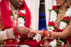 Indian bride and groom's capture during the ring exchange ritual. Indian bride and groom's capture during the ring exchange ritual.