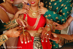 Indian bride being helped with her jewelry. Indian bride being helped with her jewelry.