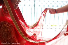 Indian bride getting help to put her wedding Ghoonghat veil on. Indian bride getting help to put her wedding Ghoonghat veil on.