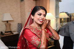 Indian bride putting earrings on Indian bride putting earrings on