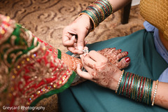 Indian bride being helped with jewelry Indian bride being helped with jewelry