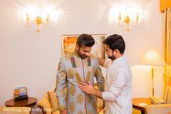 Indian groom getting his necklace on. Indian groom getting his necklace on.