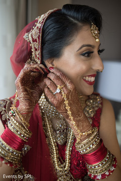 Indian bride putting jewelry on Indian bride putting jewelry on