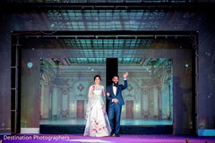 Indian bride and groom making his entrance to wedding reception Indian bride and groom making his entrance to wedding reception