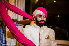 Indian groom fixing his turban on. Indian groom fixing his turban on.