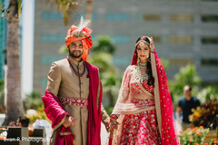 Indian bride and groom leaving the ceremony venue Indian bride and groom leaving the ceremony venue