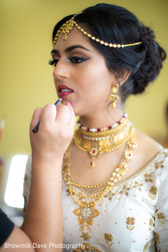 Indian bride getting makeup last touch ups for her wedding ceremony. Indian bride getting makeup last touch ups for her wedding ceremony.