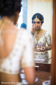 Marvelous capture of bride putting her bindi. Marvelous capture of bride putting her bindi.