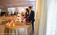 Lovely capture Indian bride and groom cutting cake together. Lovely capture Indian bride and groom cutting cake together.