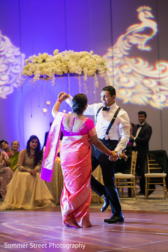Indian groom dancing with mother Indian groom dancing with mother