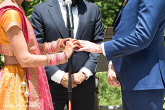 Indian bride putting wedding ring to groom capture. Indian bride putting wedding ring to groom capture.