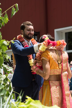 Indian groom putting flower garland to bride. Indian groom putting flower garland to bride.