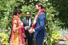 Indian bride and groom at their varmala ceremony garland exchange ritual. Indian bride and groom at their varmala ceremony garland exchange ritual.