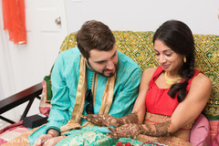 Indian bride and groom admiring the mehndi art on bride's hands. Indian bride and groom admiring the mehndi art on bride's hands.