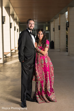 Gorgeous Indian bride and groom posing with their wedding reception outfits. Gorgeous Indian bride and groom posing with their wedding reception outfits.