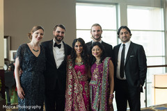 graceful Indian bride and groom posing with family. graceful Indian bride and groom posing with family.