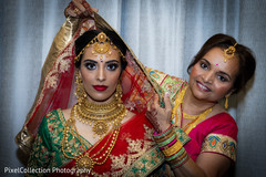 Indian bride being helped to get ready Indian bride being helped to get ready