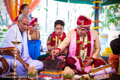 Indian groom making offerings to sacred fire Indian groom making offerings to sacred fire