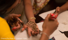 Henna artist making mehndi art Henna artist making mehndi art