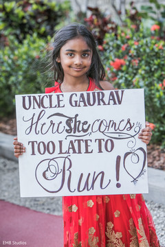 Lovely Indian guest holding a sign for groom. Lovely Indian guest holding a sign for groom.