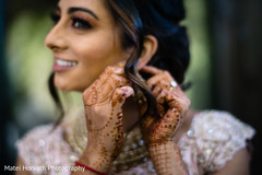 Indian bride putting earrings on capture Indian bride putting earrings on capture