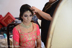 Lovely Indian bride getting her hair and makeup done. Lovely Indian bride getting her hair and makeup done.