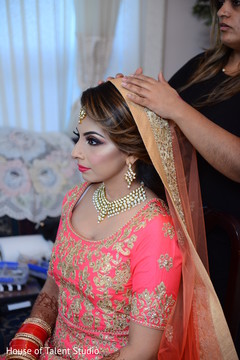 Indian bride being helped to put her Ghoonghat. Indian bride being helped to put her Ghoonghat.