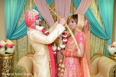 Indian groom putting flower garland to bride. Indian groom putting flower garland to bride.