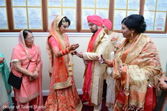 Indian groom putting wedding ring to bride. Indian groom putting wedding ring to bride.