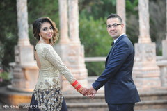 Sweet shot of Indian couple walking holding hands. Sweet shot of Indian couple walking holding hands.
