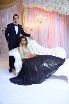 Lovely Indian bride and groom at their wedding reception stage. Lovely Indian bride and groom at their wedding reception stage.