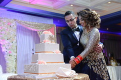 Lovely capture Indian bride and groom cutting cake together. Lovely capture Indian bride and groom cutting cake together.