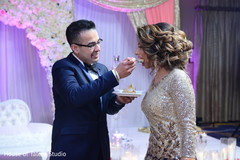 Lovely capture Indian groom giving cake to the bride. Lovely capture Indian groom giving cake to the bride.