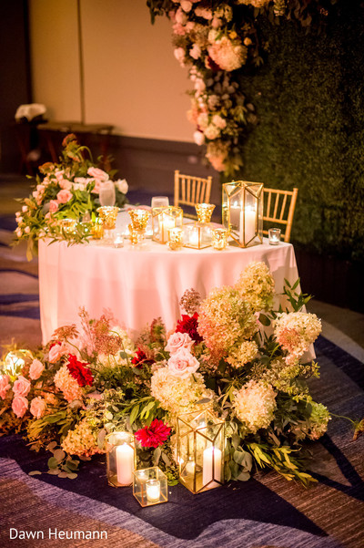 Gorgeous Indian wedding reception flowers decoration capture.