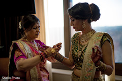 Indian bride being helped with jewelry. Indian bride being helped with jewelry.