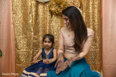 Indian bride showing mehndi art with flower girl. Indian bride showing mehndi art with flower girl.