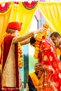Indian bride and groom at their varmala ceremony garland exchange ritual. Indian bride and groom at their varmala ceremony garland exchange ritual.